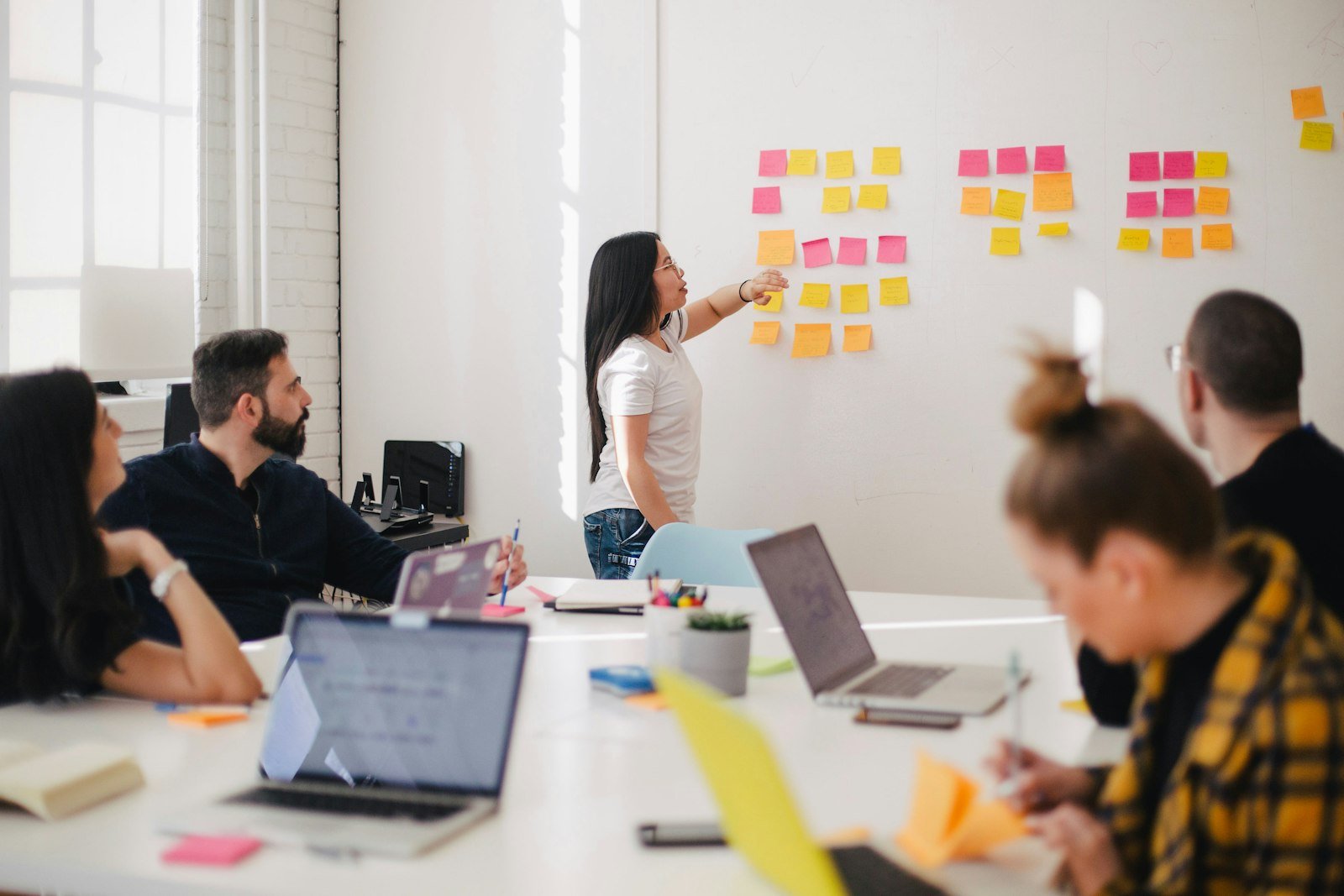 A small-group workshop with a facilitator at a whiteboard