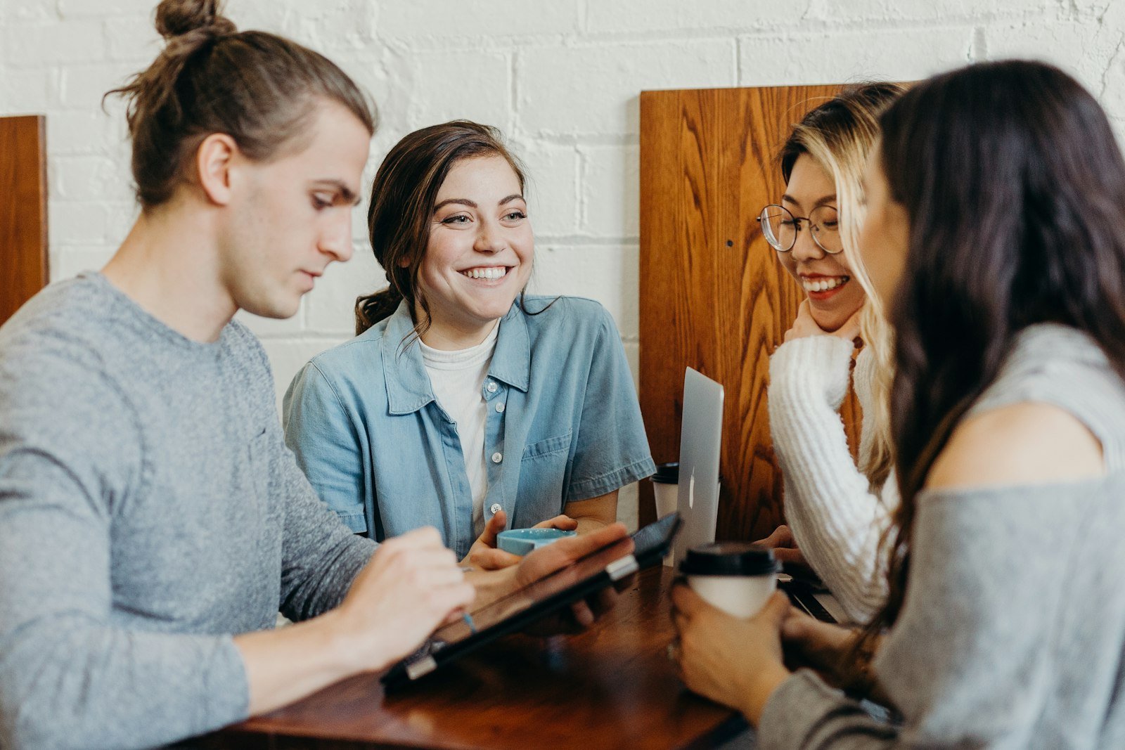 Adult learners talking together over a laptop