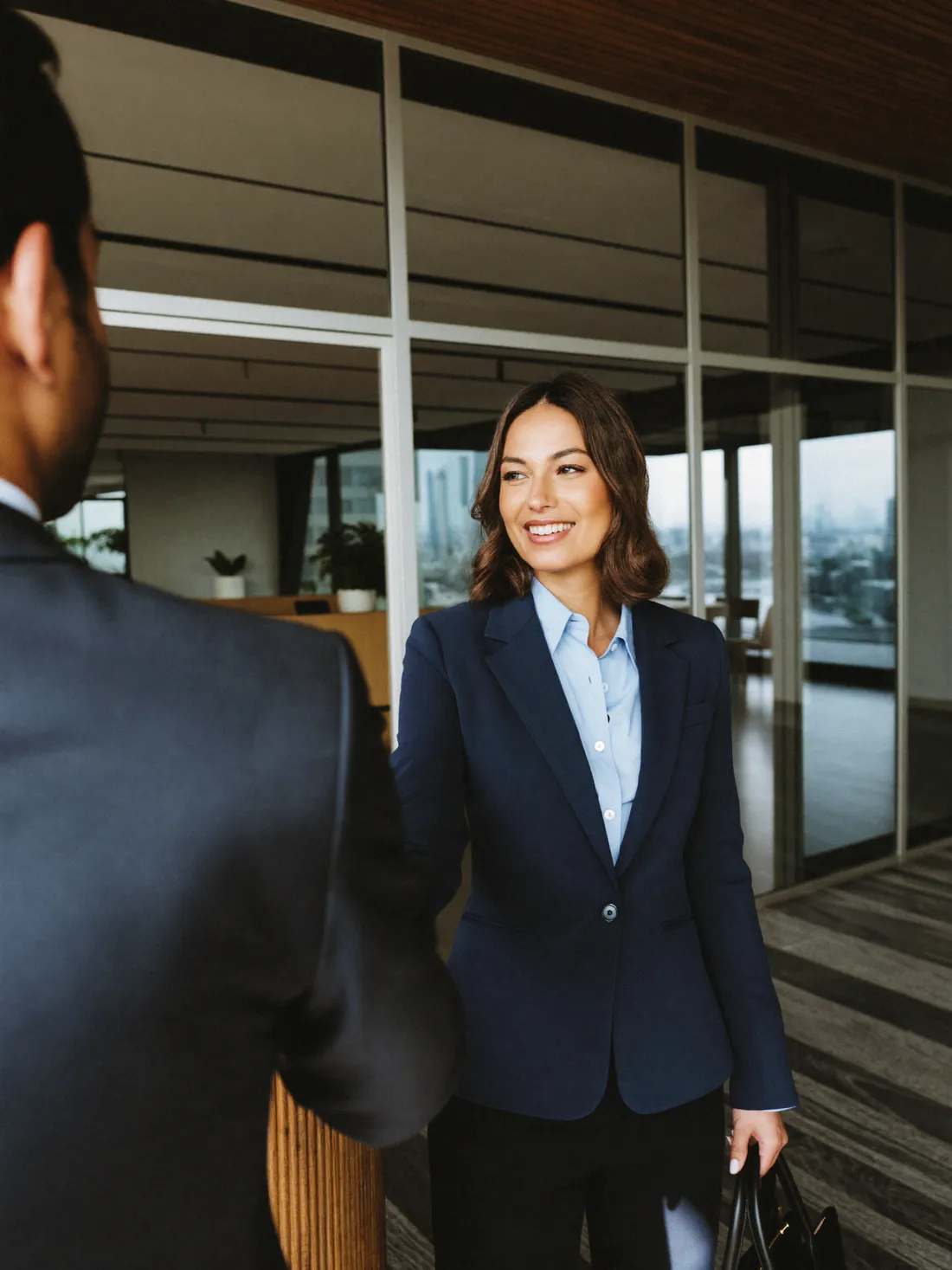 A professional greeting a client in a Doha office